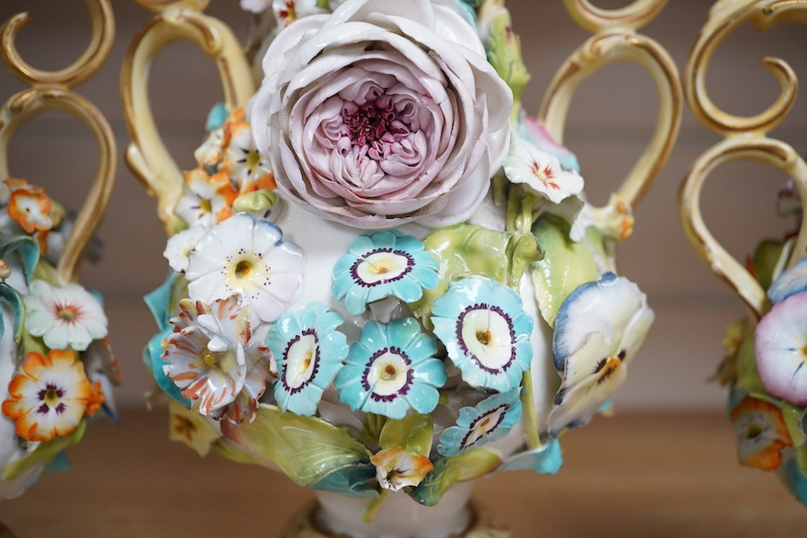 A Coalport garniture vase set with applied flowers, tallest 31cm. Condition - restored